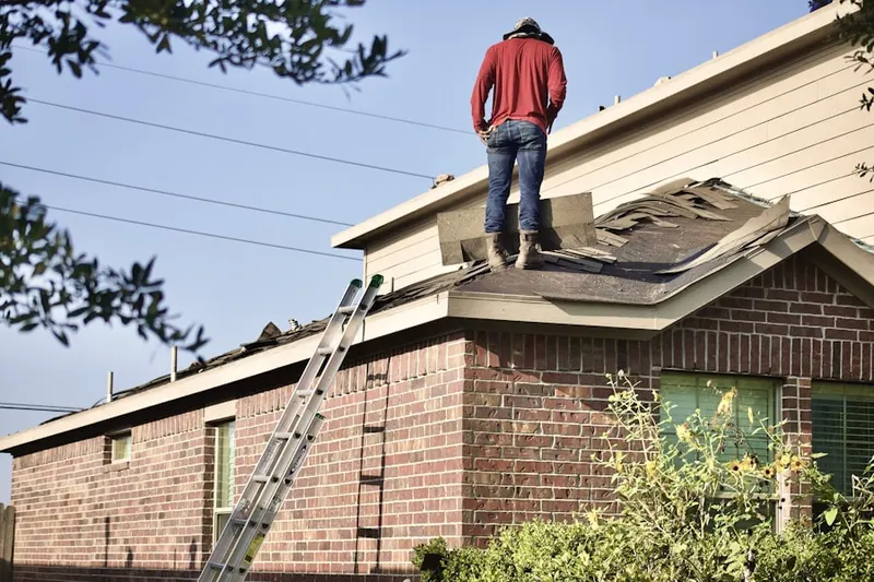 Professional roofer working on a residential roof in Montage